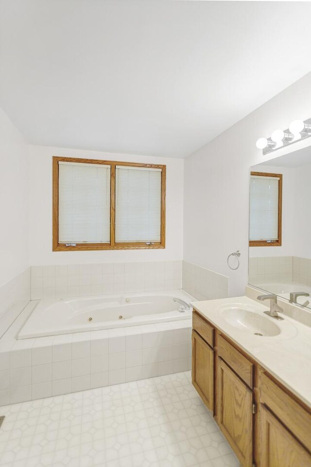924 Millcreek Cir, Elgin, IL 60123 - full bathroom with a jetted tub, vanity, and tile patterned floors