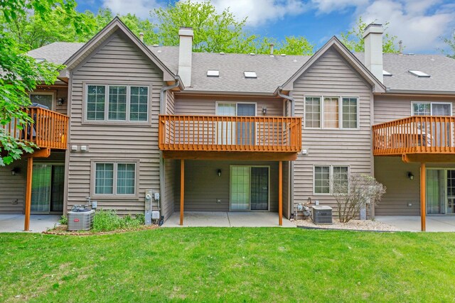 924 Millcreek Cir, Elgin, IL 60123 - back of property with a chimney, a patio, and a lawn