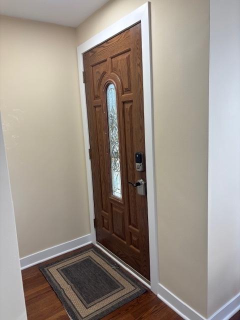 5131 S Latrobe Ave, Chicago, IL 60638 - foyer entrance with baseboards and dark wood-style flooring