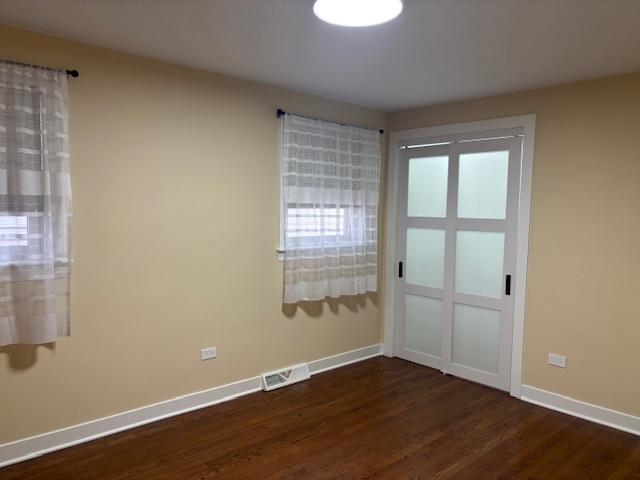 5131 S Latrobe Ave, Chicago, IL 60638 - empty room featuring dark wood finished floors and plenty of natural light