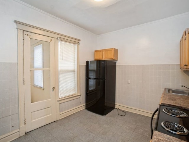 7120 S Eberhart Ave, Chicago, IL 60619 - kitchen with black appliances, tile walls, crown molding, and a wainscoted wall