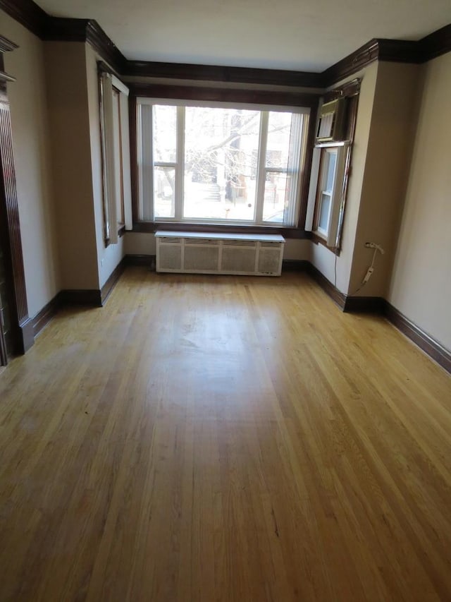 7120 S Eberhart Ave, Chicago, IL 60619 - spare room with ornamental molding, wood finished floors, and radiator heating unit