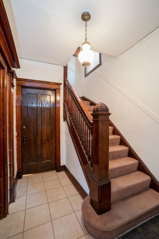 7120 S Eberhart Ave, Chicago, IL 60619 - foyer featuring stairs and light tile patterned floors