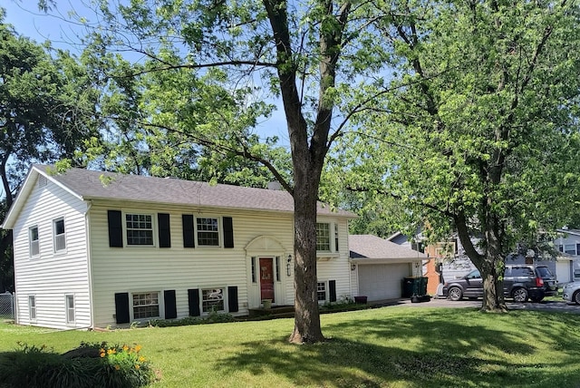 103 Shorewood Ln, Shorewood, IL 60404 - raised ranch featuring a front lawn and an attached garage
