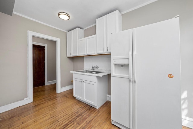 3017 E 78th St Unit 4B, Chicago, IL 60649 - kitchen featuring white refrigerator with ice dispenser, light wood-style floors, ornamental molding, white cabinets, and light countertops