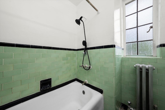 3017 E 78th St Unit 4B, Chicago, IL 60649 - bathroom with radiator, tile walls, wainscoting, and washtub / shower combination