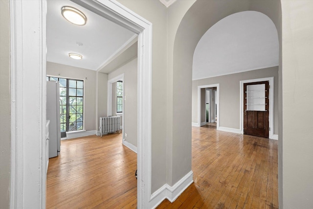 3017 E 78th St Unit 4B, Chicago, IL 60649 - foyer with radiator, hardwood / wood-style flooring, arched walkways, and ornamental molding