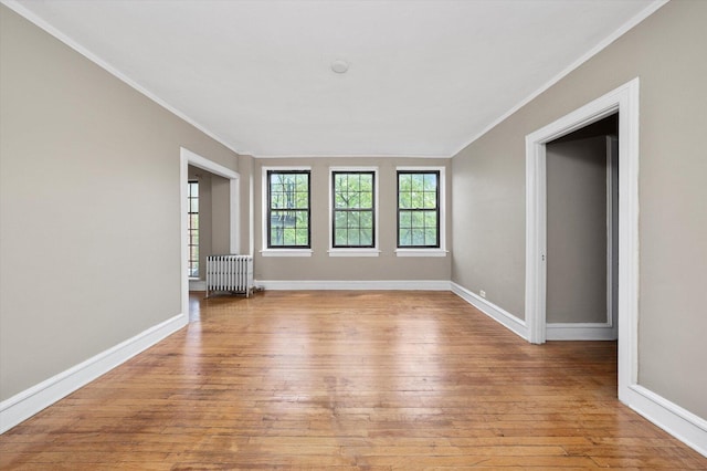 3017 E 78th St Unit 4B, Chicago, IL 60649 - spare room with radiator, ornamental molding, and light wood-style floors