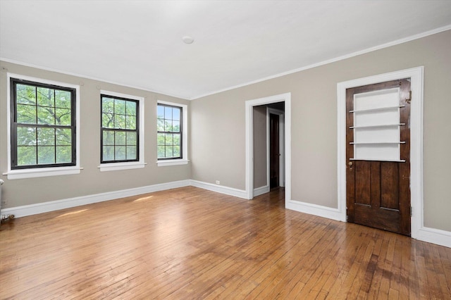 3017 E 78th St Unit 4B, Chicago, IL 60649 - spare room with wood-type flooring, ornamental molding, and plenty of natural light