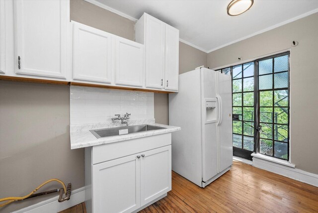 3017 E 78th St Unit 4B, Chicago, IL 60649 - kitchen with white fridge with ice dispenser, white cabinetry, tasteful backsplash, light wood finished floors, and crown molding