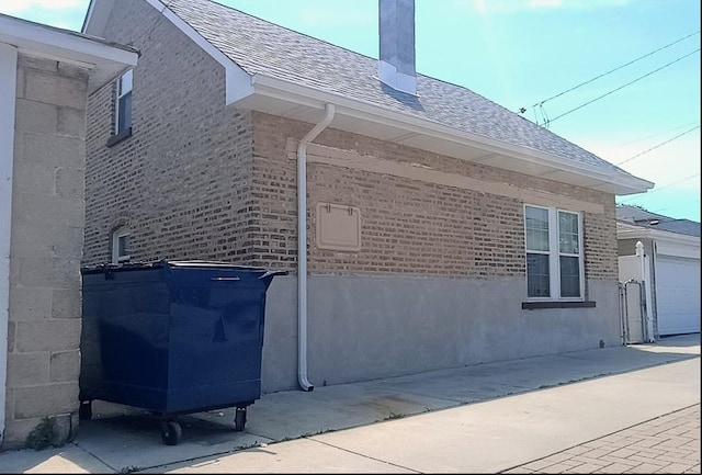 6084 S 75th Ave, Summit, IL 60501 - view of home's exterior featuring a shingled roof, brick siding, and a chimney