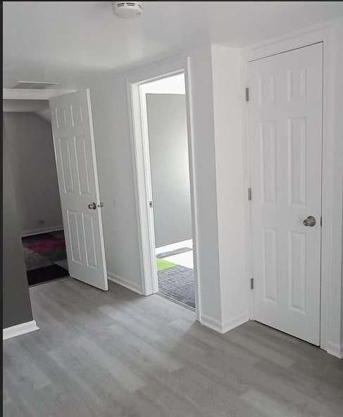 6084 S 75th Ave, Summit, IL 60501 - unfurnished bedroom featuring wood finished floors and baseboards