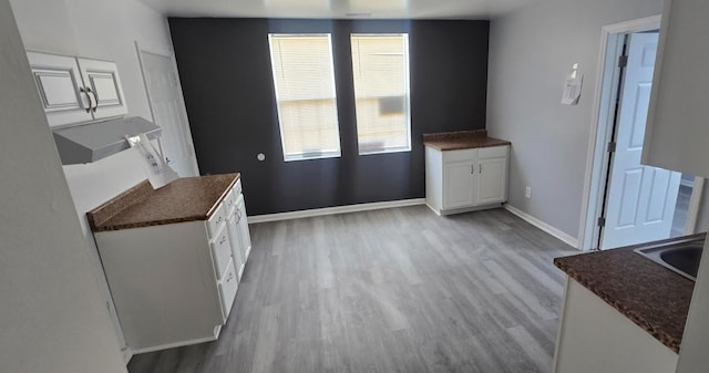 6084 S 75th Ave, Summit, IL 60501 - unfurnished dining area featuring light wood-style floors and baseboards