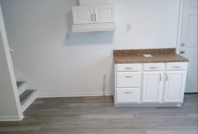 6084 S 75th Ave, Summit, IL 60501 - kitchen with white cabinetry, dark countertops, and light wood-style floors