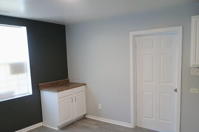 6084 S 75th Ave, Summit, IL 60501 - unfurnished dining area featuring light wood-style flooring and baseboards