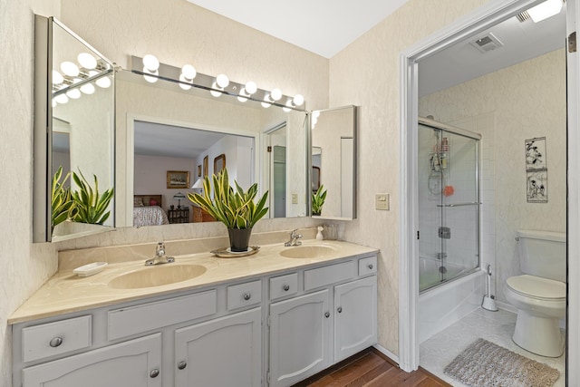 50 Lake Blvd Unit 627, Buffalo Grove, IL 60089 - ensuite bathroom featuring double vanity, combined bath / shower with glass door, and wood finished floors
