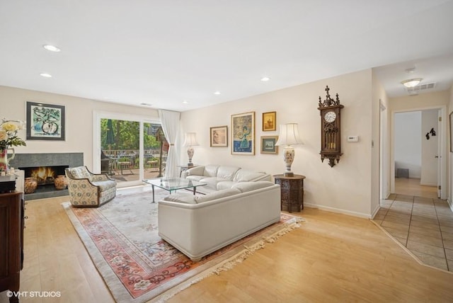 1280 Rudolph Rd Unit 1K, Northbrook, IL 60062 - living area featuring light wood finished floors, a warm lit fireplace, and recessed lighting