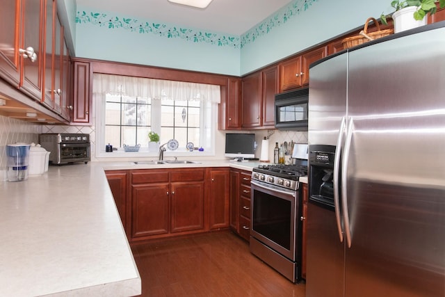 750 Pearson St Unit 904, Des Plaines, IL 60016 - kitchen featuring appliances with stainless steel finishes, light countertops, tasteful backsplash, and dark wood-style flooring