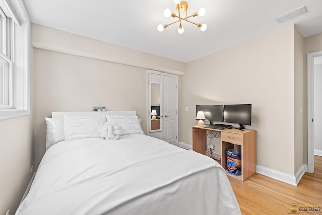 3507 N Reta Ave Unit 4, Chicago, IL 60657 - bedroom with light wood-style floors and a chandelier