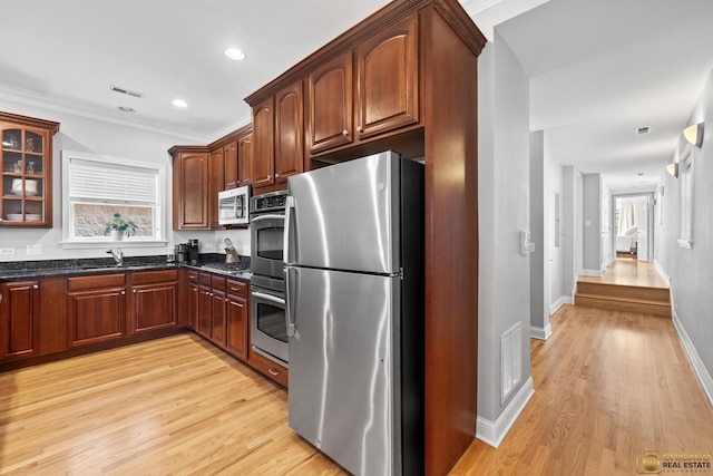3507 N Reta Ave Unit 4, Chicago, IL 60657 - kitchen with appliances with stainless steel finishes, light wood finished floors, glass insert cabinets, dark stone counters, and recessed lighting