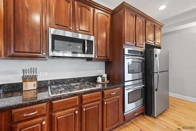 3507 N Reta Ave Unit 4, Chicago, IL 60657 - kitchen featuring stainless steel appliances, light wood finished floors, crown molding, dark stone countertops, and recessed lighting