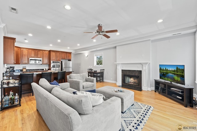 3507 N Reta Ave Unit 4, Chicago, IL 60657 - living area featuring a ceiling fan, light wood-style floors, recessed lighting, ornamental molding, and a high end fireplace