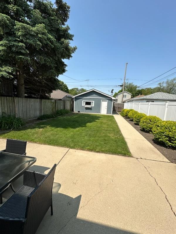 3708 N Oketo Ave, Chicago, IL 60634 - fenced backyard with a patio, an outdoor structure, and outdoor dining space