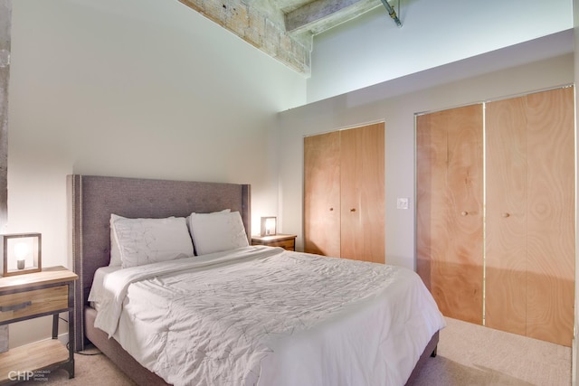 20 N State St Unit 909, Chicago, IL 60602 - bedroom with a high ceiling, two closets, carpet flooring, and beam ceiling