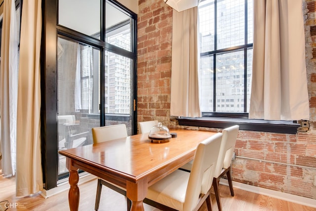 20 N State St Unit 909, Chicago, IL 60602 - dining room with wood finished floors and brick wall