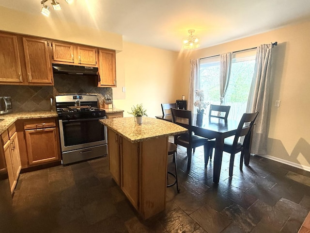 26296 N Green St Unit 5C, Mundelein, IL 60060 - kitchen with stainless steel appliances, range hood, decorative backsplash, stone tile floors, and light stone countertops