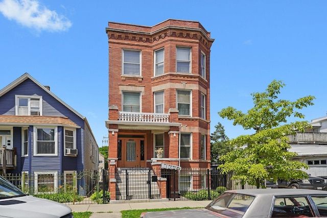 3608 W Wolfram St, Chicago, IL 60618 - view of property featuring a fenced front yard, a gate, brick siding, cooling unit, and uncovered parking