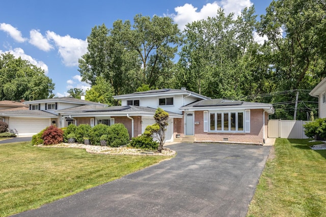 9070 Shady Ln, Hickory Hills, IL 60457 - split level home with driveway, brick siding, roof mounted solar panels, and an attached garage