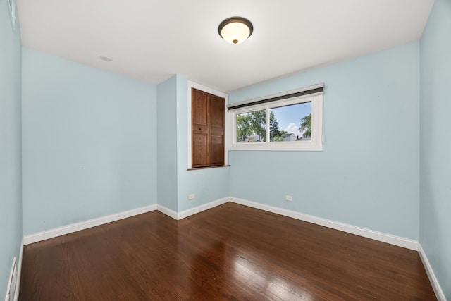 9070 Shady Ln, Hickory Hills, IL 60457 - spare room featuring baseboards and dark wood-type flooring