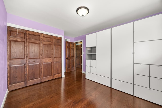 9070 Shady Ln, Hickory Hills, IL 60457 - unfurnished bedroom featuring dark wood-style floors and a closet