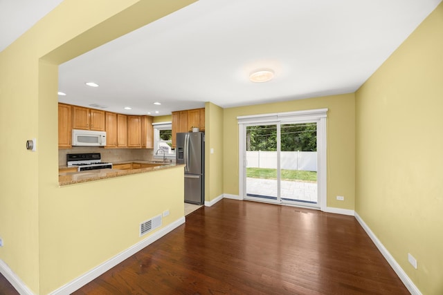 9070 Shady Ln, Hickory Hills, IL 60457 - kitchen with white appliances, dark wood finished floors, backsplash, recessed lighting, and a peninsula