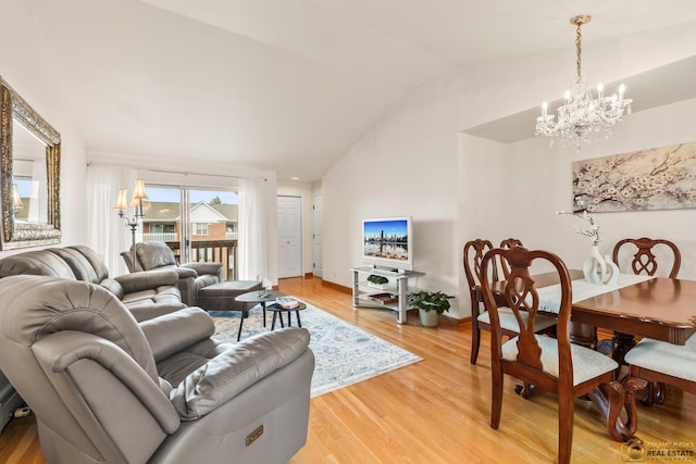 6561 W School Ave Unit 305C, Chicago, IL 60634 - living room featuring a chandelier, vaulted ceiling, and light wood-style flooring