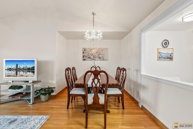 6561 W School Ave Unit 305C, Chicago, IL 60634 - dining area featuring a chandelier, vaulted ceiling, and wood finished floors