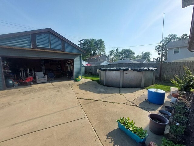 4421 W 87th St, Hometown, IL 60456 - view of property exterior featuring a fenced backyard, a detached garage, and an outbuilding
