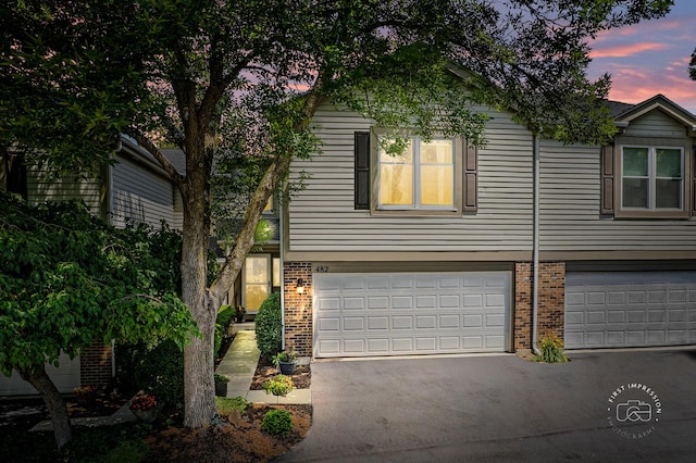 482 River Front Cir, Naperville, IL 60540 - view of front of home featuring brick siding, an attached garage, and asphalt driveway