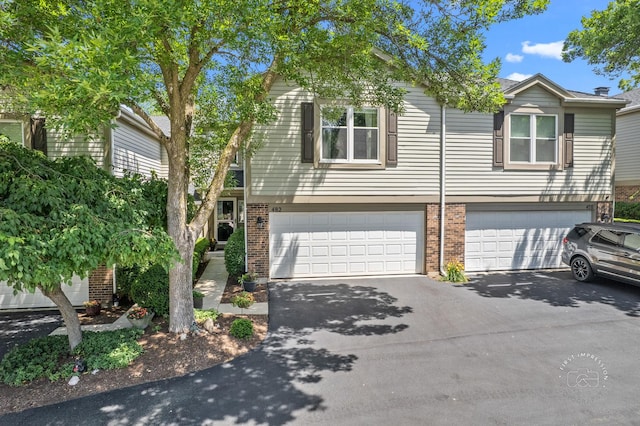 482 River Front Cir, Naperville, IL 60540 - view of front of house with brick siding, driveway, and an attached garage