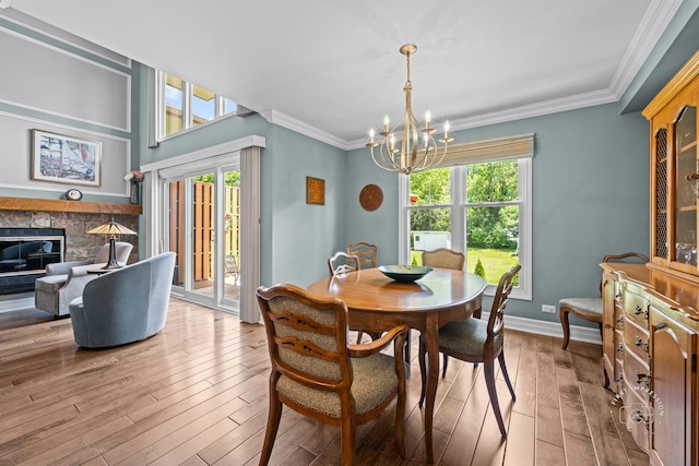 482 River Front Cir, Naperville, IL 60540 - dining area featuring a chandelier, wood-type flooring, crown molding, and a fireplace