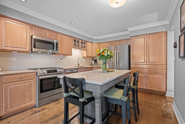 482 River Front Cir, Naperville, IL 60540 - kitchen featuring stainless steel appliances, wood-type flooring, light stone counters, a kitchen bar, and backsplash