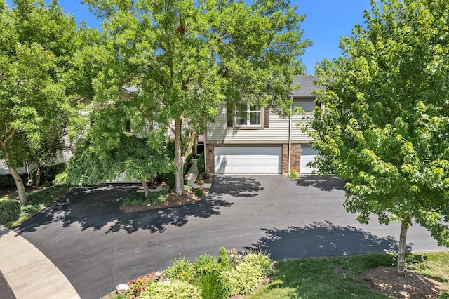 482 River Front Cir, Naperville, IL 60540 - obstructed view of property with asphalt driveway, an attached garage, and brick siding