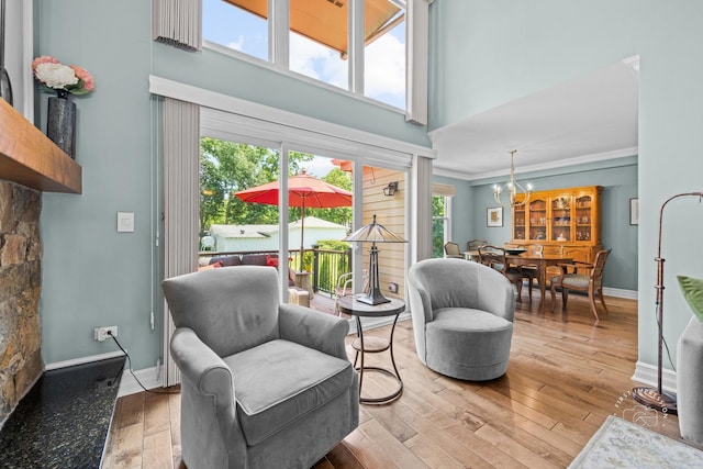 482 River Front Cir, Naperville, IL 60540 - living area featuring a chandelier, wood finished floors, ornamental molding, and a towering ceiling