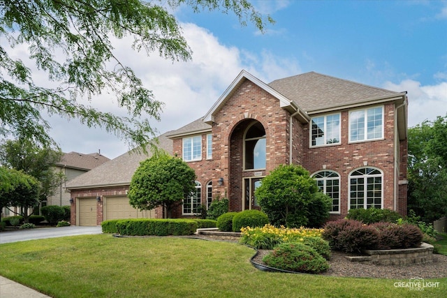 10660 Great Egret Dr, Orland Park, IL 60467 - traditional home featuring brick siding, a garage, driveway, a front yard, and roof with shingles