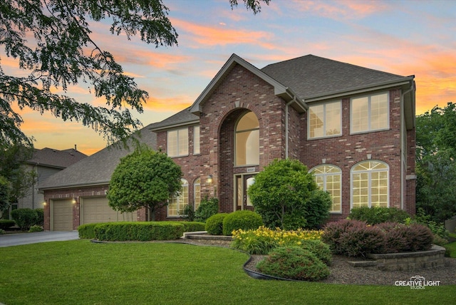 10660 Great Egret Dr, Orland Park, IL 60467 - traditional-style home featuring an attached garage, a yard, brick siding, and driveway