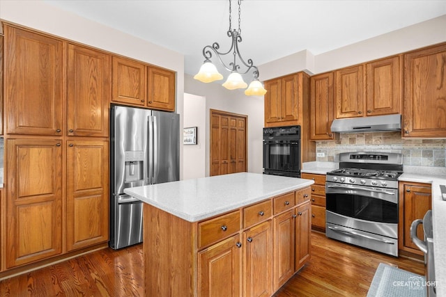 10660 Great Egret Dr, Orland Park, IL 60467 - kitchen with appliances with stainless steel finishes, under cabinet range hood, brown cabinetry, and dark wood-style floors