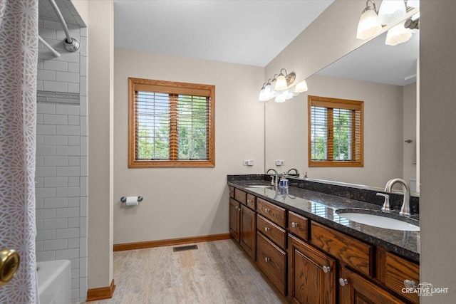 10660 Great Egret Dr, Orland Park, IL 60467 - bathroom with wood finished floors, double vanity, and shower / bath combo