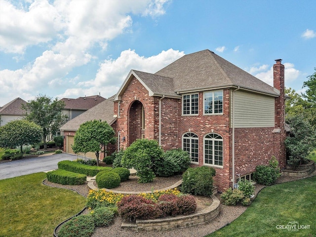 10660 Great Egret Dr, Orland Park, IL 60467 - view of front of house featuring brick siding, asphalt driveway, roof with shingles, a front yard, and a chimney