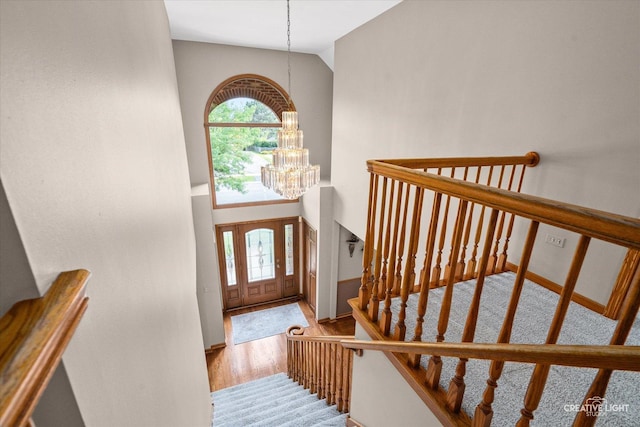 10660 Great Egret Dr, Orland Park, IL 60467 - entryway featuring a chandelier, wood finished floors, stairway, and high vaulted ceiling